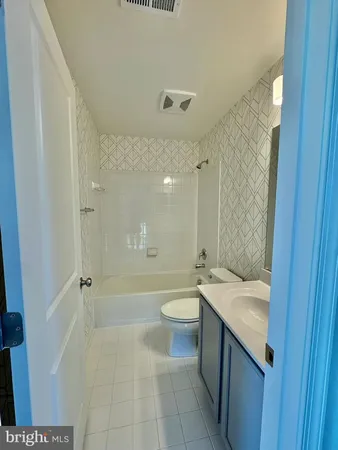 a bathroom with a double vanity sink toilet and shower