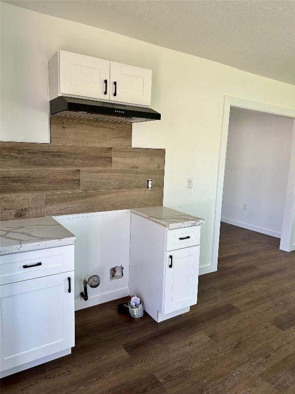102 Georgia Street Houston, TX 77029 - Photo 6 of 15 a kitchen with granite countertop white cabinets and a wooden floor