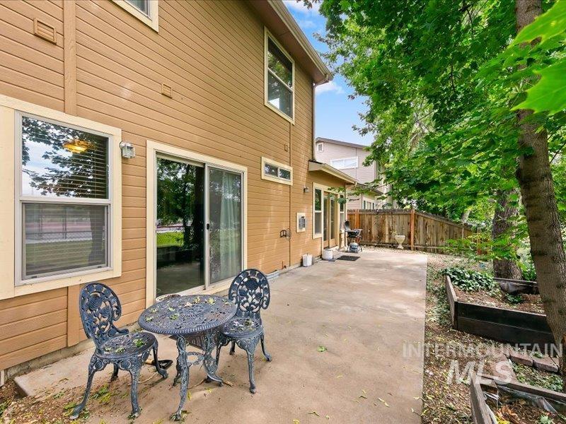 7342 West Gillis Road Boise, ID 83714 - Photo 19 of 23 Expansive concrete patio with direct access to interior spaces through a sliding glass door and double French doors