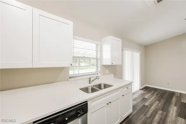 a kitchen with a sink and cabinets