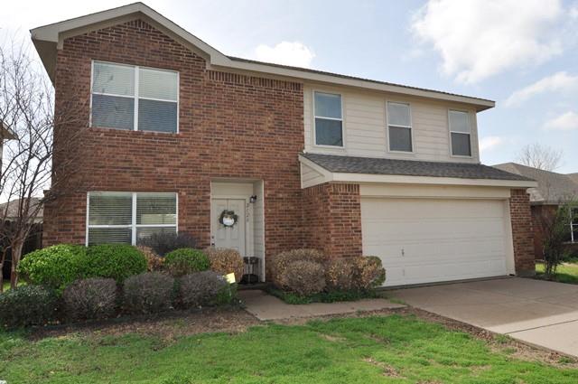 a front view of a house with a garden and plants
