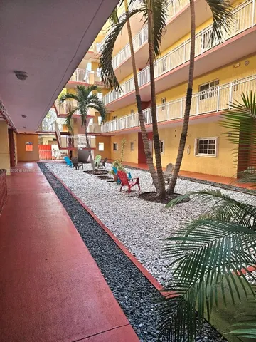a view of a backyard with wooden fence