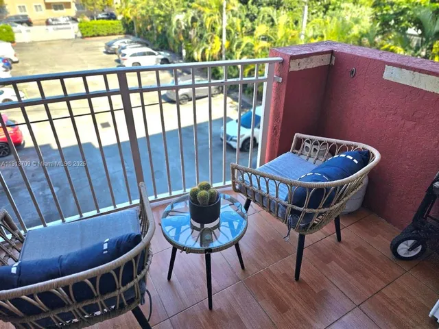 a view of a chairs and table in the patio