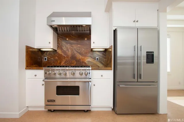 a kitchen with cabinets and stainless steel appliances