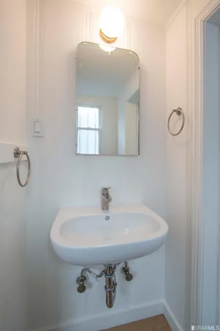 a bathroom with a sink and mirror