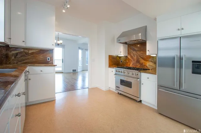a kitchen with granite countertop a stove and a refrigerator