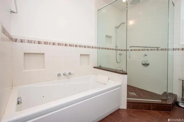 a bathroom with a bathtub and a shower