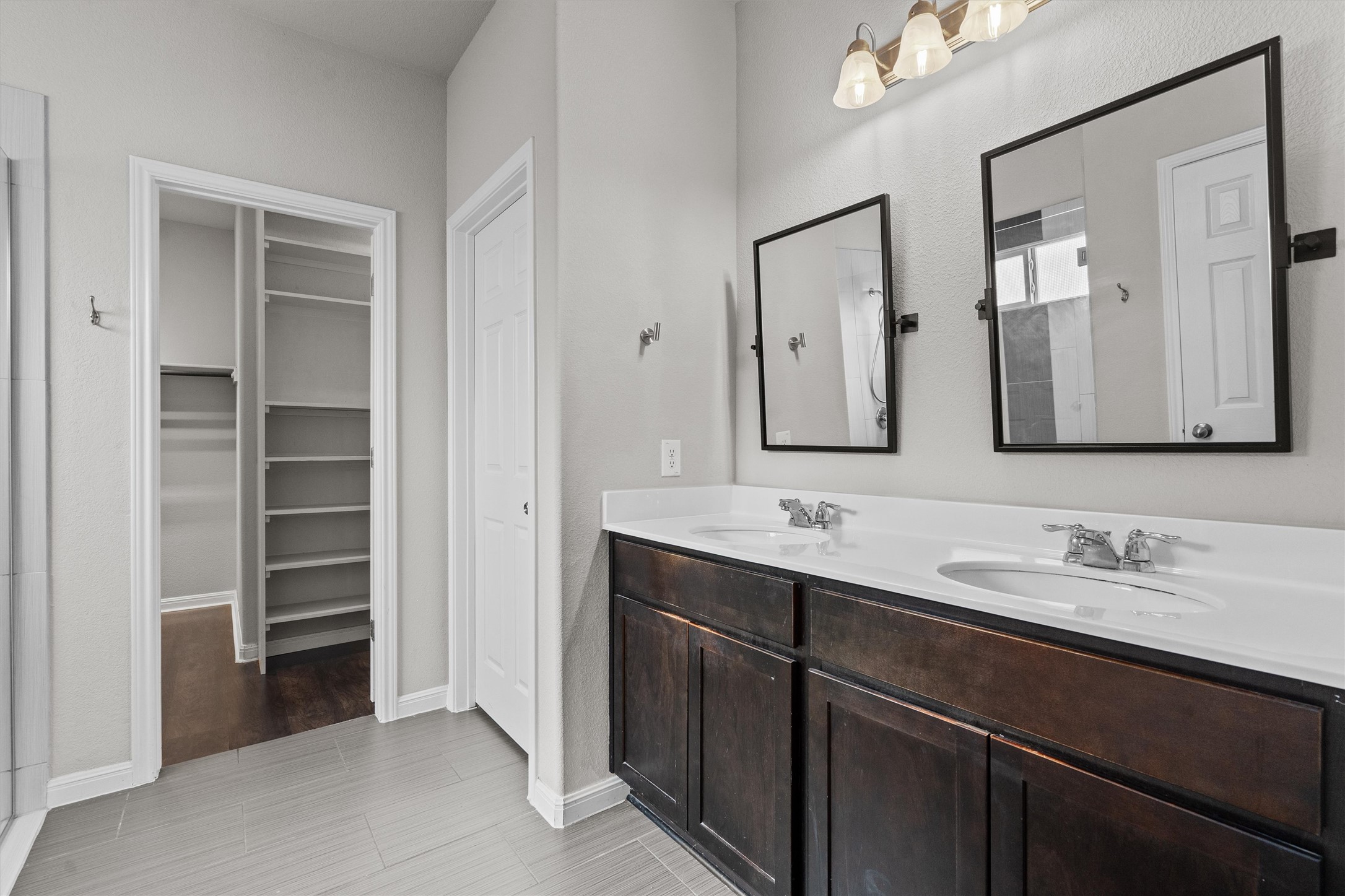 7709 Menchaca Road, Unit 22 Austin, TX 78745 - Photo 14 of 35 a bathroom with a double vanity sink and a mirror