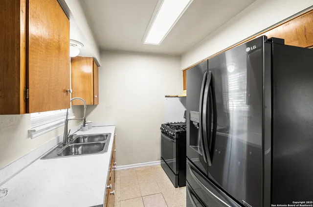 a kitchen with a refrigerator and a sink