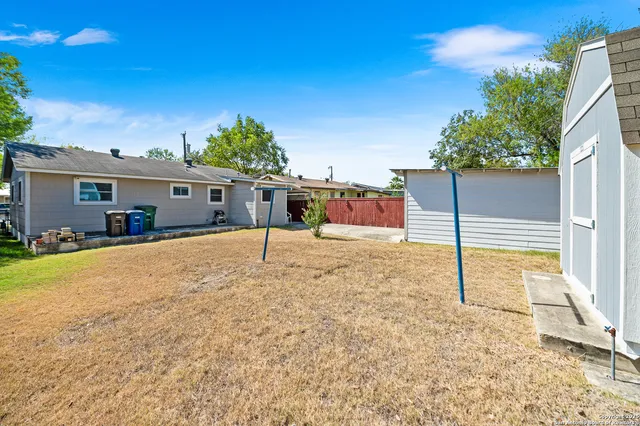 a view of an house with backyard space and garden