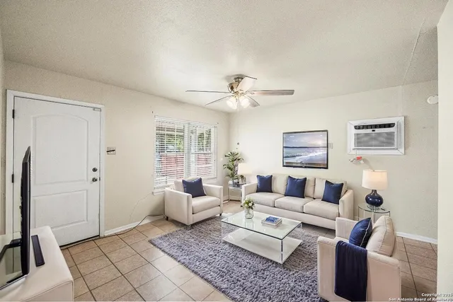 a living room with furniture and a window