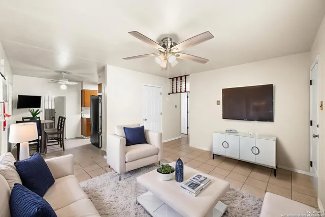 a living room with furniture and a flat screen tv