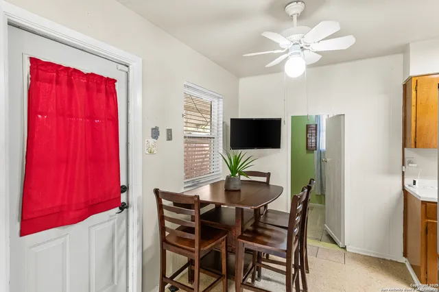 a view of a dining room with furniture and a flat screen tv