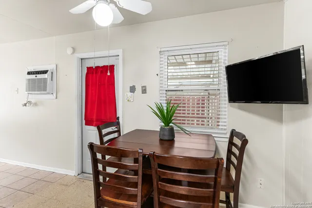 a dining room with furniture and wooden floor