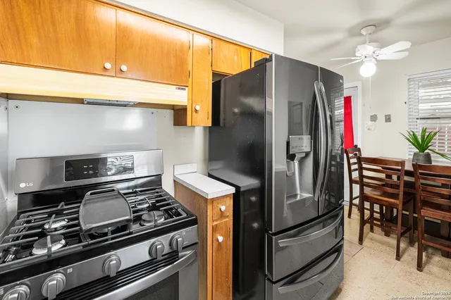 a kitchen with stainless steel appliances granite countertop a stove and a refrigerator