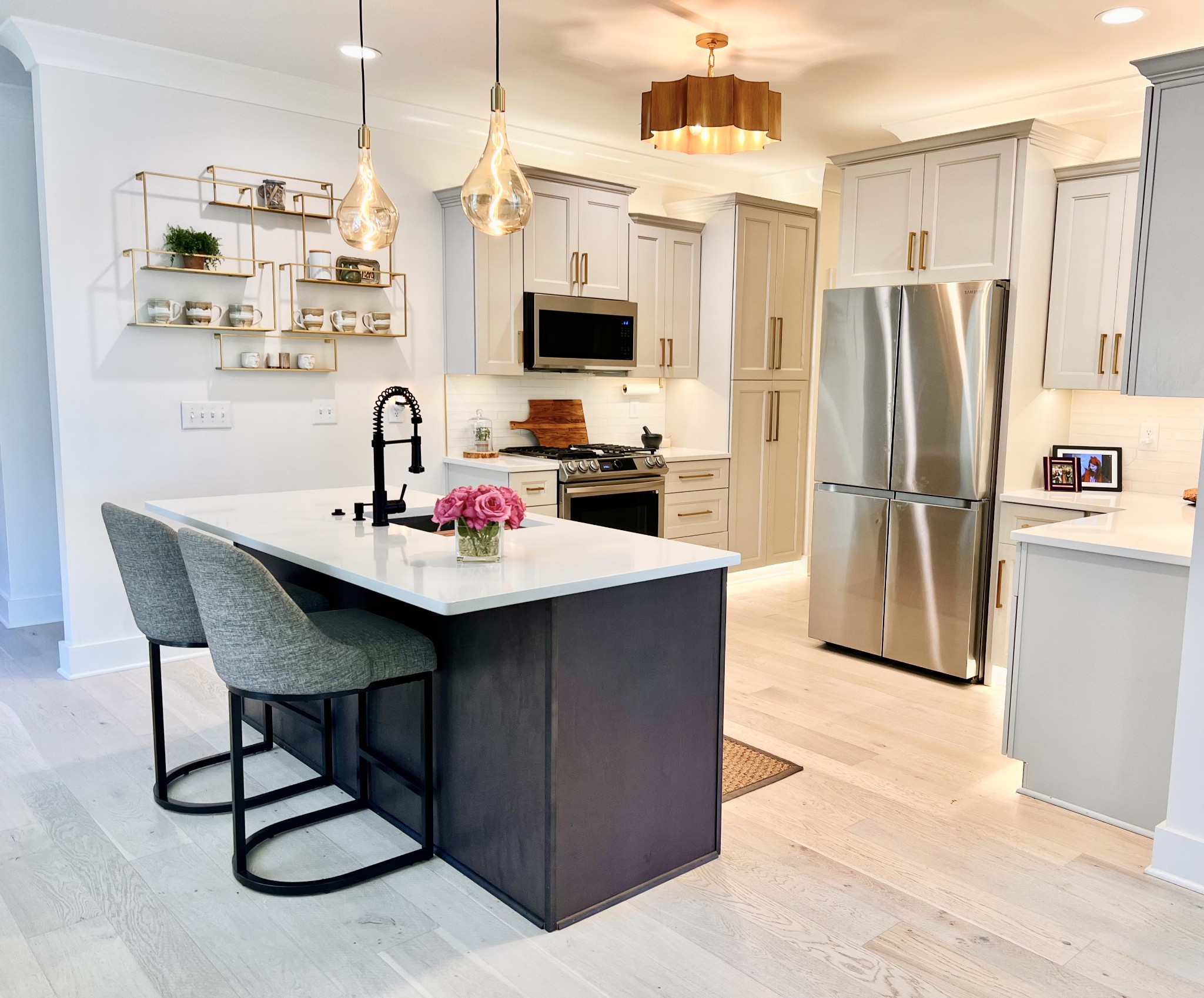 657 Nickolas Drive, Unit 657 Lebanon, TN 37087 - Photo 5 of 27 a kitchen with stainless steel appliances kitchen island granite countertop a table chairs and a refrigerator