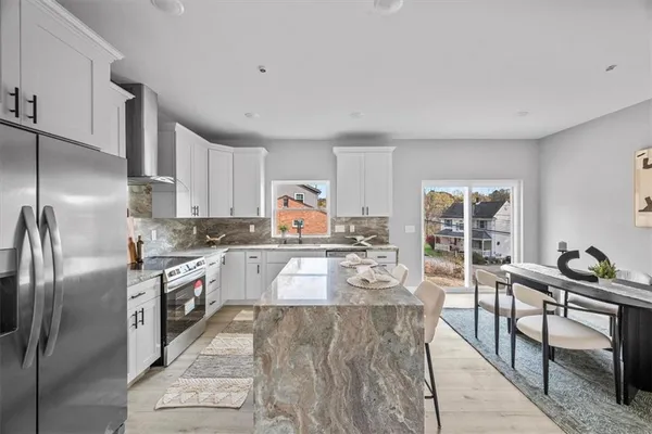 a kitchen with granite countertop lots of counter top space and stainless steel appliances