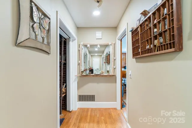 a view of gallery with wooden floor