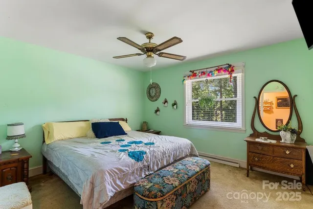 a bedroom with a bed mirror and a window