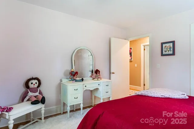 a bedroom with a bed and a dresser in it