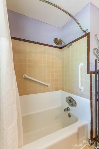 a bathroom with a bathtub and shower