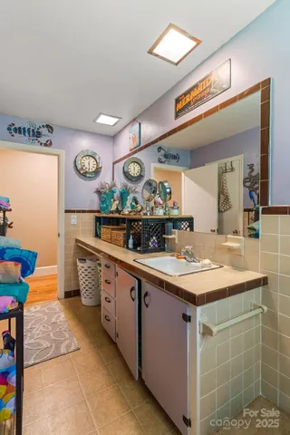 a bathroom with a sink a vanity and a large mirror