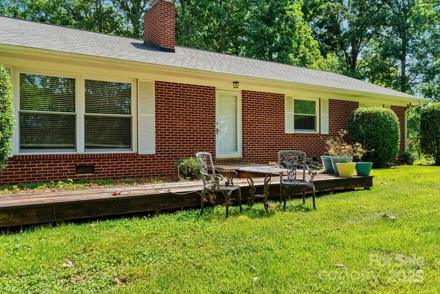 a front view of a house with a yard table and chairs
