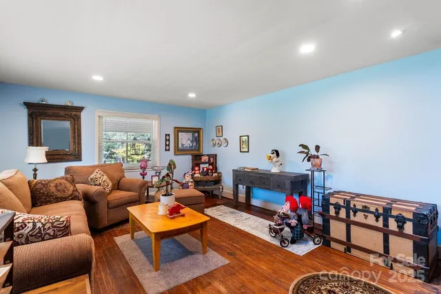 a living room with furniture a couch and a dining table