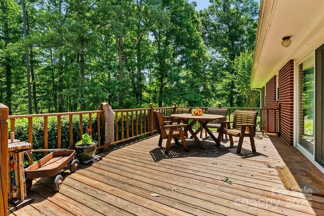 a view of a dinning table and chairs on the roof deck