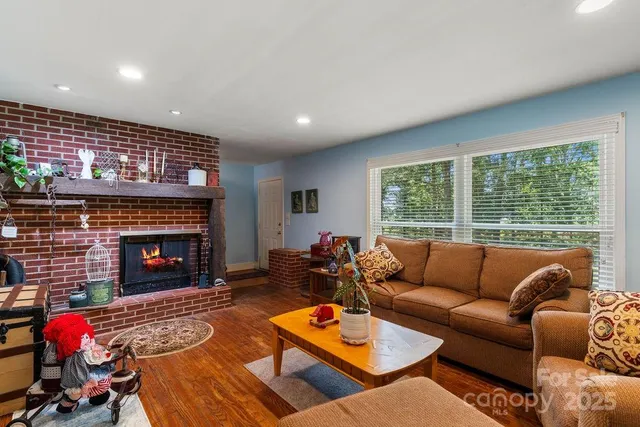 a living room with furniture fireplace and window