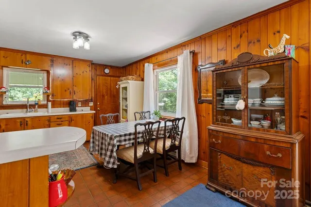 a dining room with furniture and wooden floor