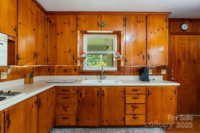 a kitchen with stainless steel appliances granite countertop a sink and a wooden cabinets