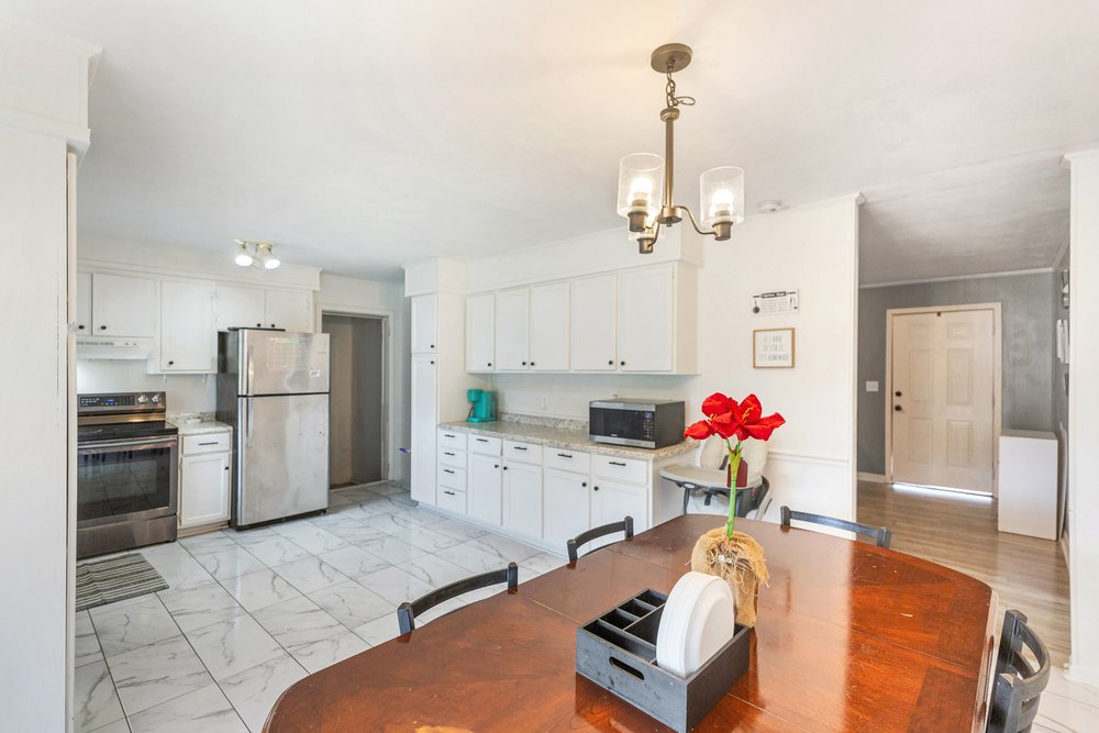 920 White Cut Road Walhalla, SC 29691 - Photo 21 of 23 This spacious kitchen and dining area features abundant cabinetry, gleaming tile flooring, and a welcoming atmosphere.