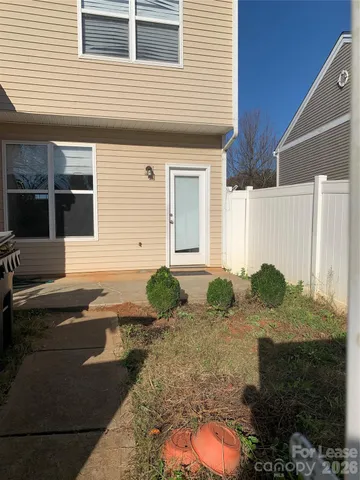 a backyard of a house with outdoor seating