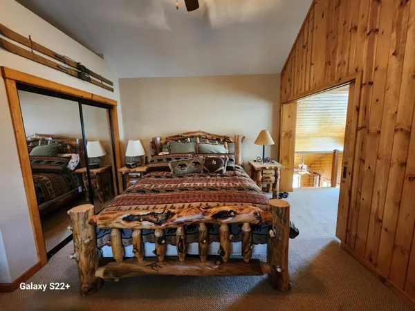 a bedroom with a bed next to a window