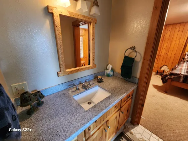 a bathroom with a sink a vanity and mirror