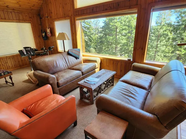 a view of a living room with furniture and a large window