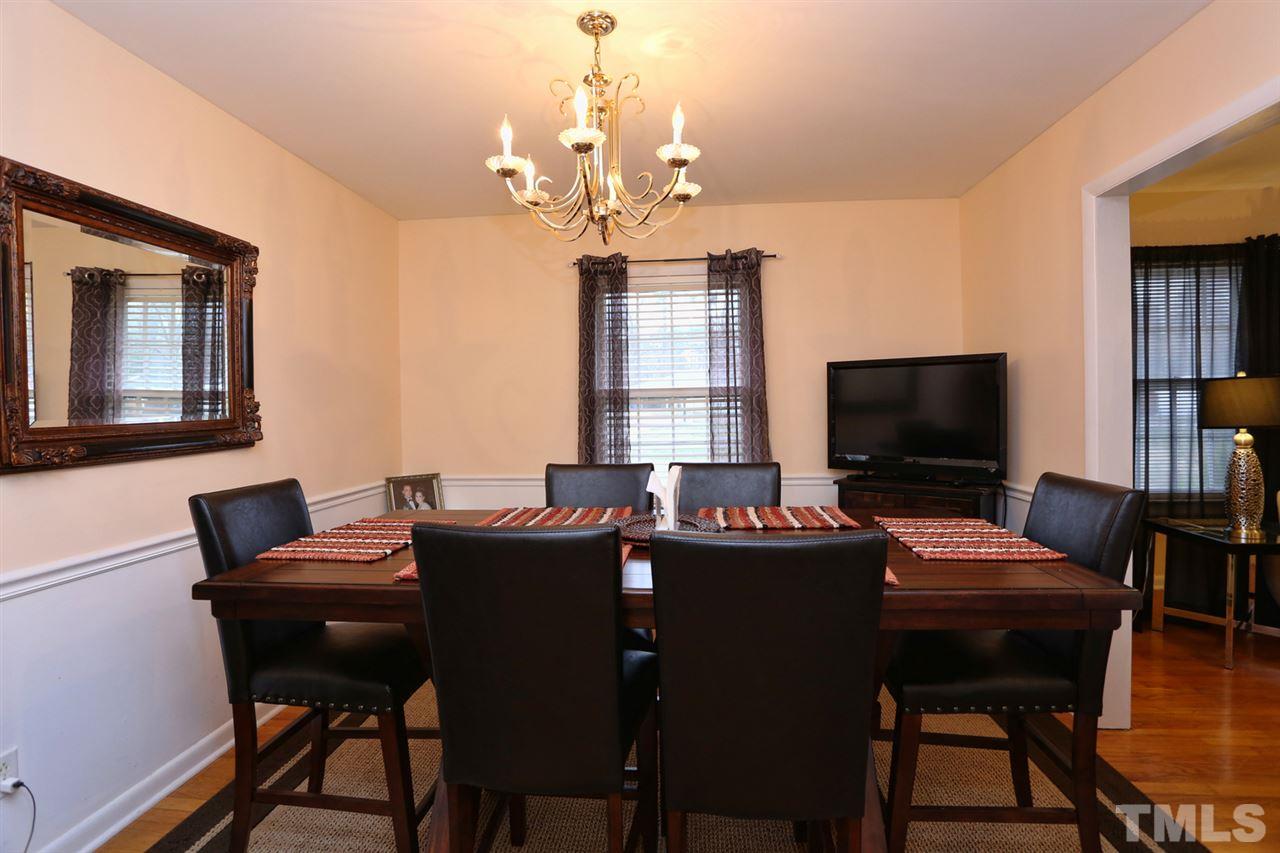 3917 Buffaloe Road Raleigh, NC 27604 - Photo 14 of 24 a view of a dining room with furniture and a chandelier