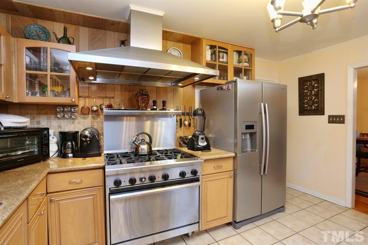 3917 Buffaloe Road Raleigh, NC 27604 - Photo 3 of 24 a kitchen with stainless steel appliances granite countertop a stove and a refrigerator