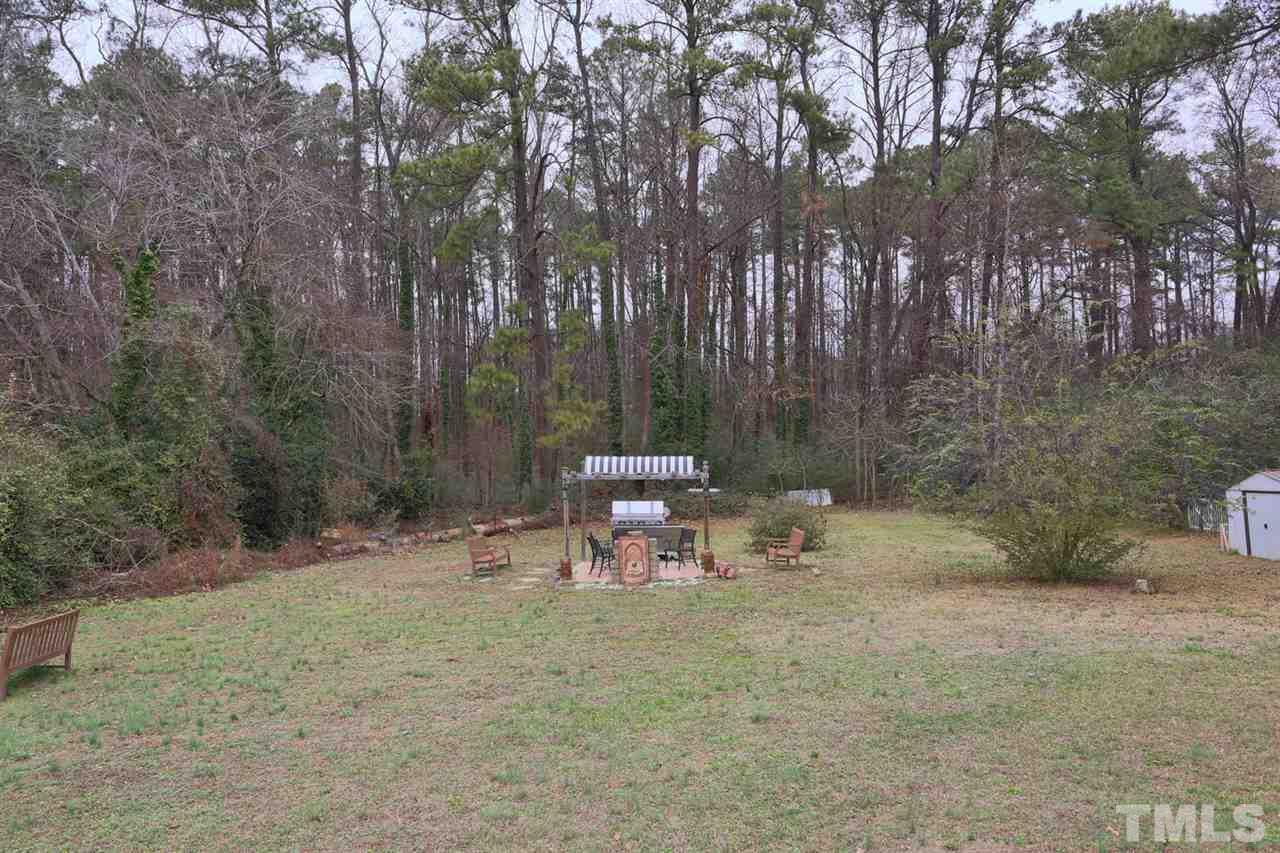 3917 Buffaloe Road Raleigh, NC 27604 - Photo 23 of 24 a view of a bench in the middle of a forest