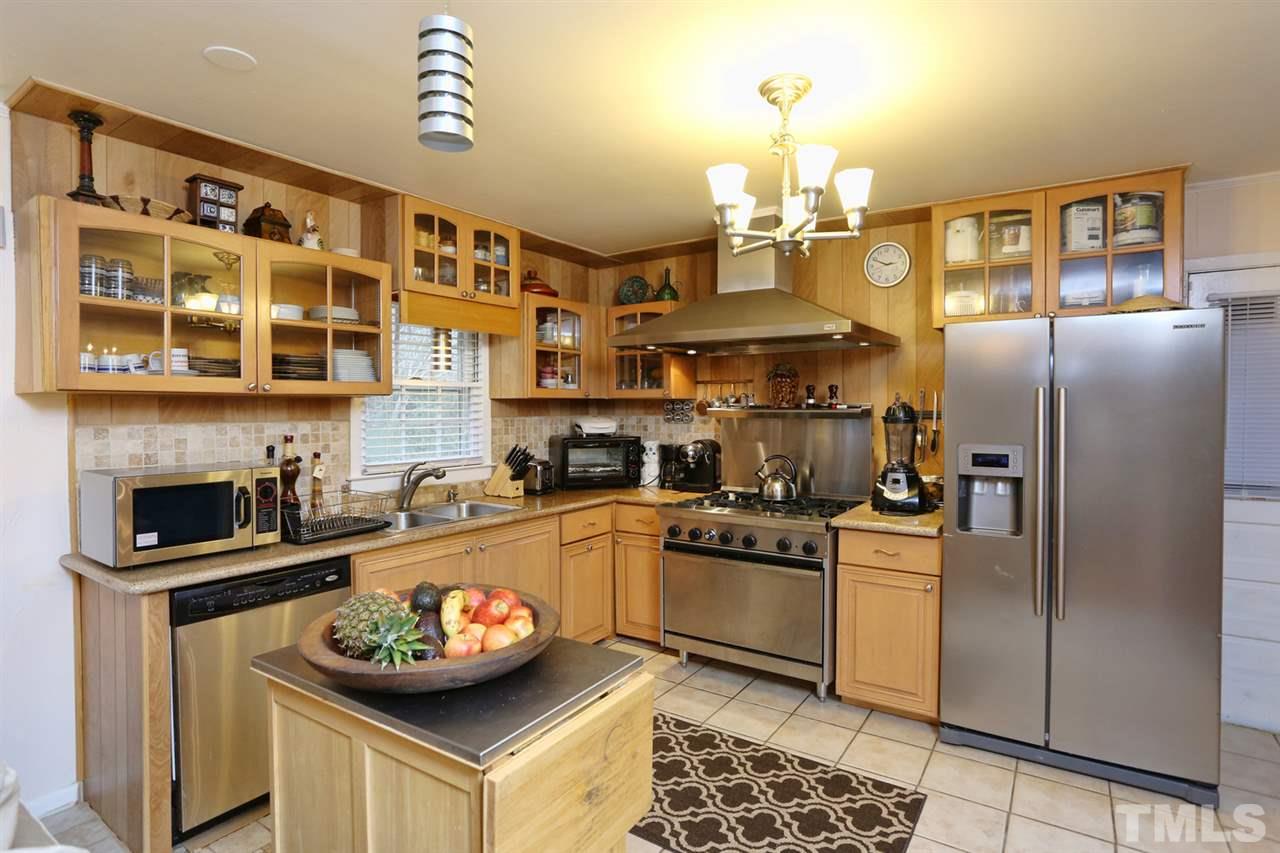 3917 Buffaloe Road Raleigh, NC 27604 - Photo 5 of 24 a kitchen with stainless steel appliances granite countertop a sink and cabinets
