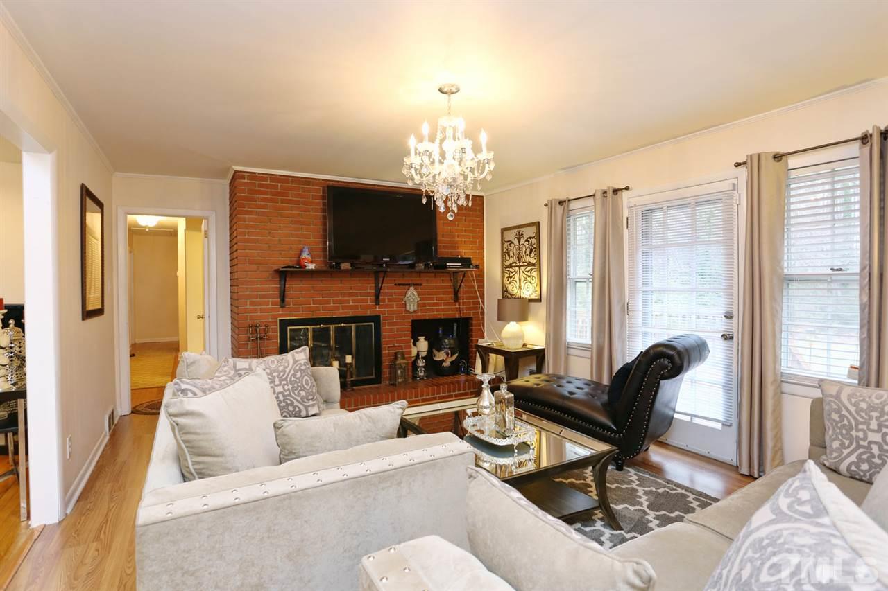 3917 Buffaloe Road Raleigh, NC 27604 - Photo 9 of 24 a living room with fireplace furniture and a flat screen tv
