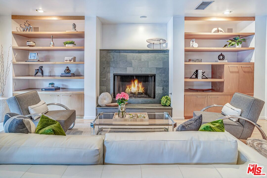 4216 Woodcliff Road Sherman Oaks, CA 91403 - Photo 11 of 56 a living room with furniture and a fireplace