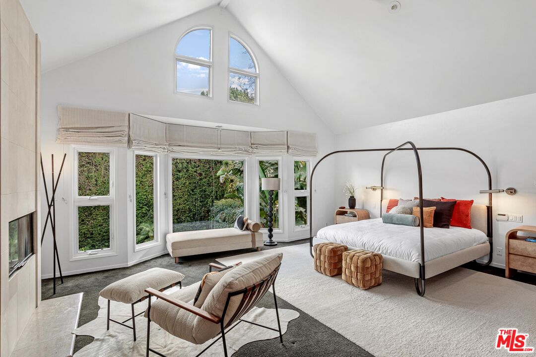 4216 Woodcliff Road Sherman Oaks, CA 91403 - Photo 15 of 56 a bedroom with a bed and a large window