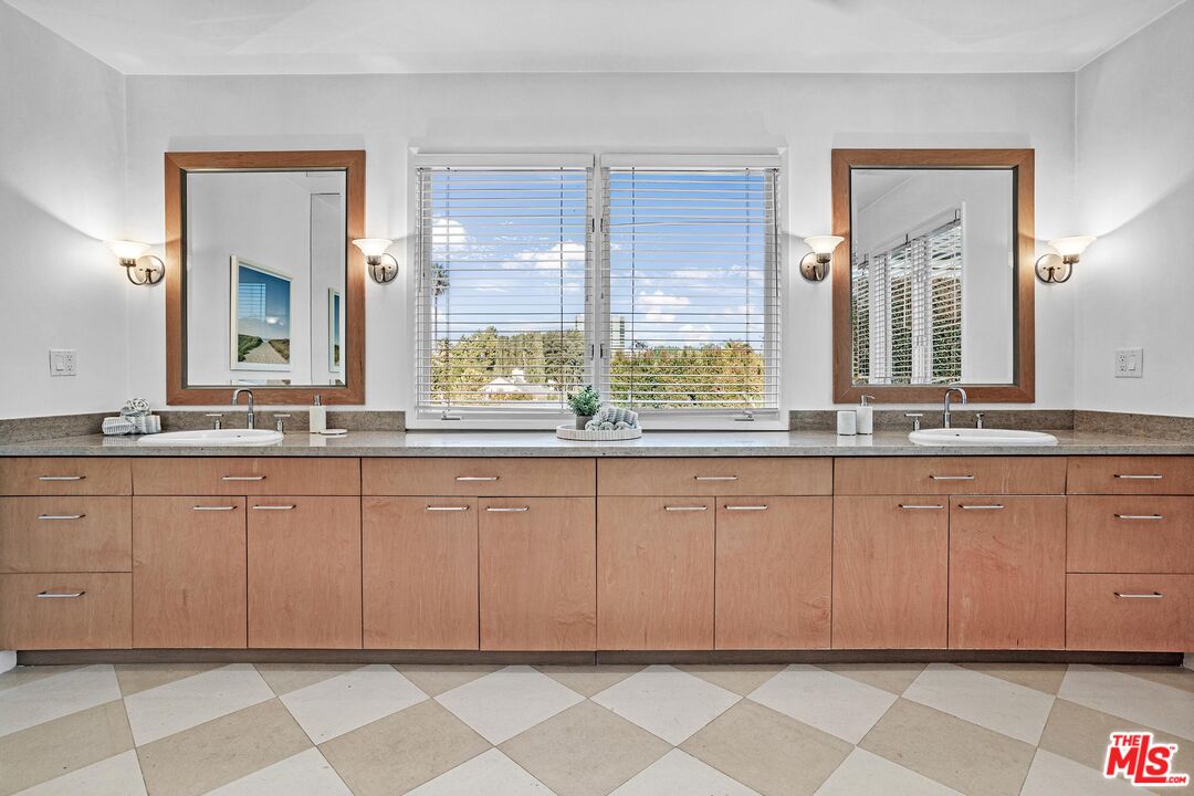 4216 Woodcliff Road Sherman Oaks, CA 91403 - Photo 17 of 56 a spacious bathroom with a granite countertop sink and a mirror