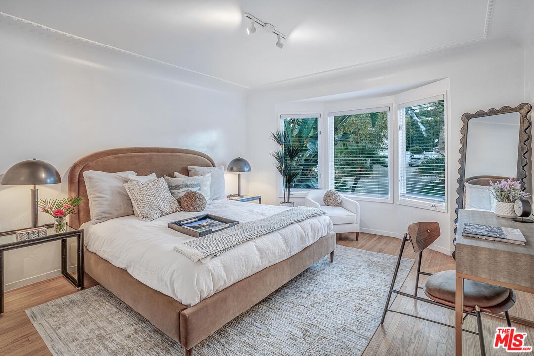 4216 Woodcliff Road Sherman Oaks, CA 91403 - Photo 22 of 56 a bedroom with bed and a large window
