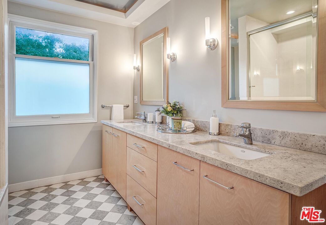 4216 Woodcliff Road Sherman Oaks, CA 91403 - Photo 24 of 56 a bathroom with a granite countertop sink and a mirror
