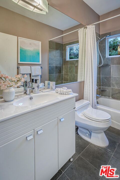 4216 Woodcliff Road Sherman Oaks, CA 91403 - Photo 28 of 56 a bathroom with a sink a toilet a mirror and shower
