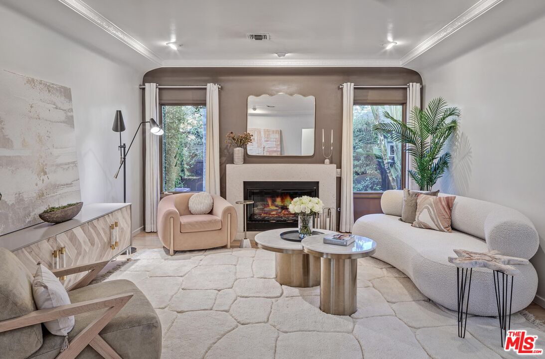 4216 Woodcliff Road Sherman Oaks, CA 91403 - Photo 3 of 56 a living room with furniture and a fireplace