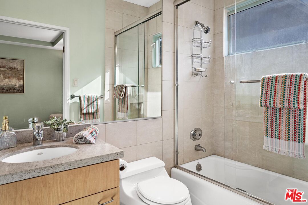 4216 Woodcliff Road Sherman Oaks, CA 91403 - Photo 31 of 56 a bathroom with a granite countertop sink toilet and shower
